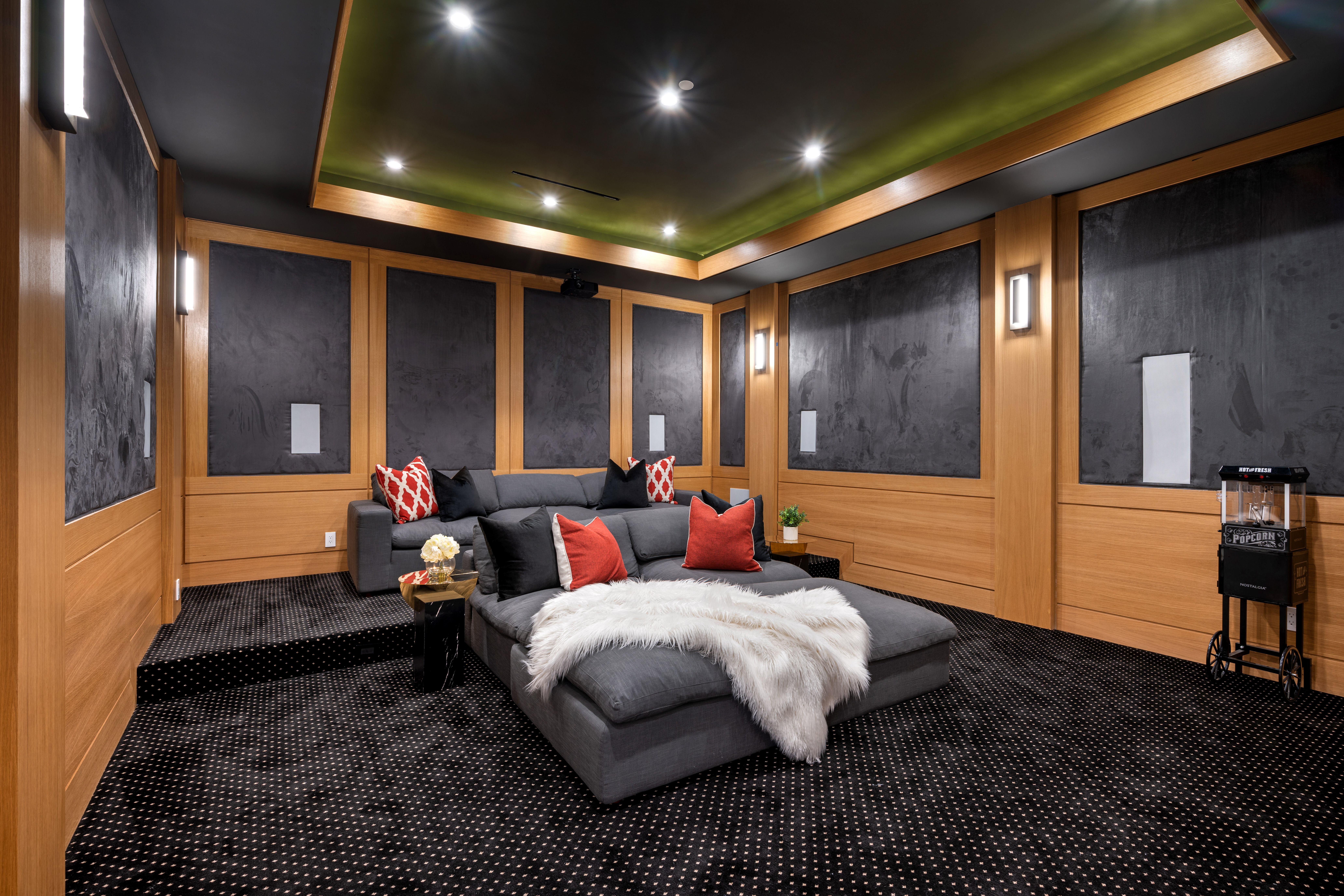 Home Theater with comfy grey couch and dolby atmos system.